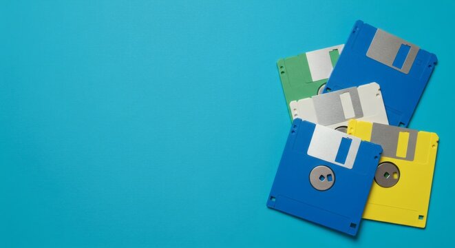 AI image features a collection of colorful floppy disks, representing vintage data storage technology, scattered pleasingly on a blue background.