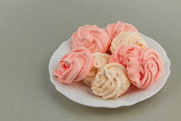 Colorful meringue cookies arranged on a white plate
