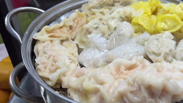 mix hot portion of varieties steamed dumplings or dum sum basket foods on table