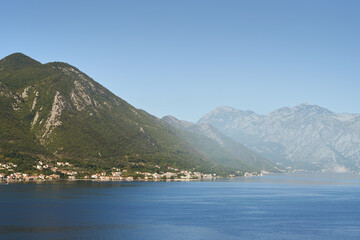 Misty valley view with forested hills and water