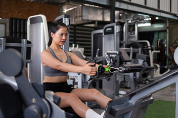 Fototapeta premium Young woman exercising with her arms