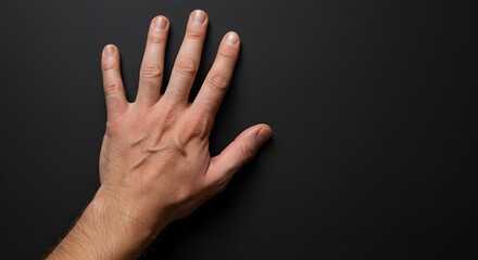 Human Hand on Dark Surface