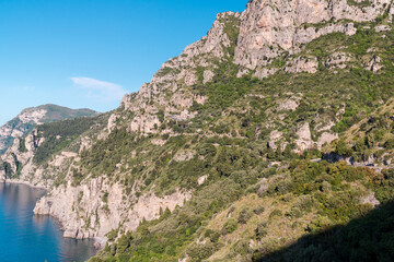 A mountain in Campania, Italy, on the blue-green waters of the Tyrrhenian Sea, a mountain road that leads to the town of Positano on the Amalfi Coast.