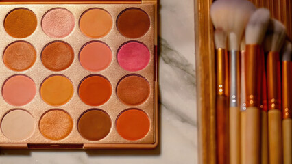 Overhead shot of makeup artist palette featuring vibrant pink blushes and eyeshadows beauty setup stylish environment