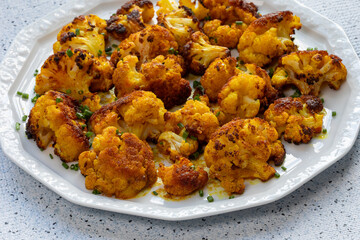 Turmeric Roasted Cauliflower on a serving plate. Great healthy snack. 
