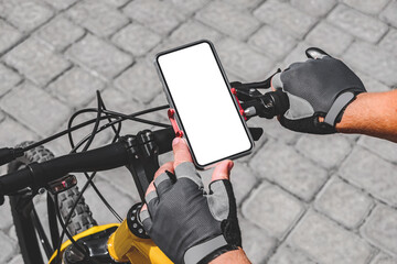 Close-up of a man's hand holding a smartphone mockup on the handlebars of a bicycle.