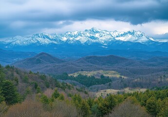 Fototapeta premium Snow Capped Mountains Under a Dramatic Cloudy Sky