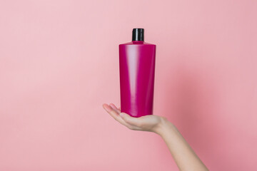 Cosmetic unbranded bottle for shampoo, mask, lotion in hand. Concept of beauty. Product cosmetic...