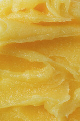 Abstract yellow sugar body exfoliating scrub texture. Melon scrub for body or face pilling. Skin care body moisturizer scrub background.