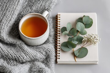 Cozy Flat Lay with Tea, Notebook, and Blanket on White Background for Winter or Autumn Lifestyle Mockup