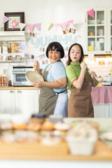 Small business owners are selling .Asian bakery  cake shop owner enjoy posting picture and review her cake on social media or online marketing streaming publish for advertising small business .