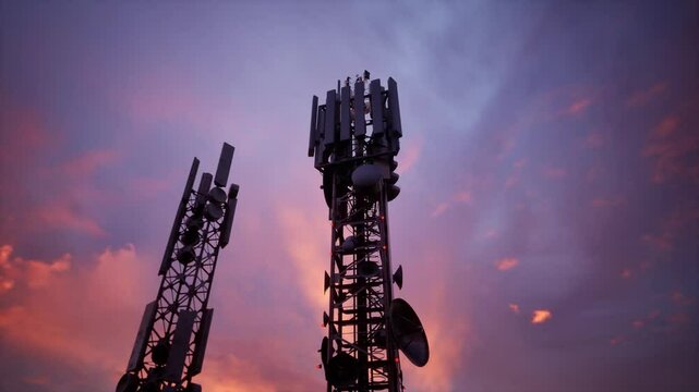 A Tall Cell Tower Stands Against A Vibrant Sunset