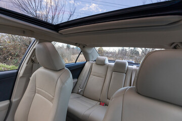 Portland, OR, USA -  Rear seat view of a 2013 Japanese sedan with beige leather interior,...