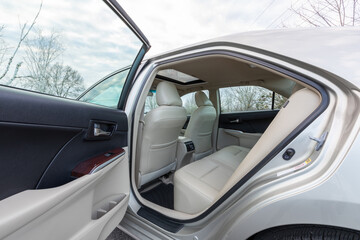 Portland, OR, USA -  Rear seat view of a 2013 Japanese sedan with beige leather interior,...