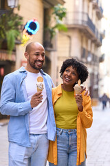 Fototapeta premium Happy tourists couple eating ice cream in barcelona, spain, gothic quarter