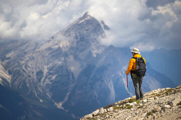 Hiker enjoys the view from Lagazuoi mountain over the italian Dolomites.