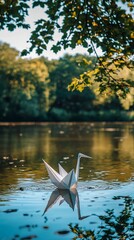 Fototapeta premium Origami crane on a calm river, tranquil scene under trees