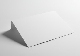 Abstract white paper folded in a triangle shape casting a shadow on a white background