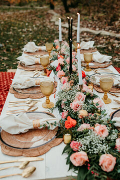 Boho Picnic Setup with Candles and Floral Arrangements for Wedding