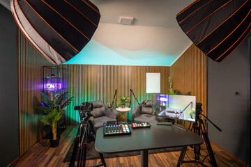 Professional podcast recording space with modern lighting and clean interior.