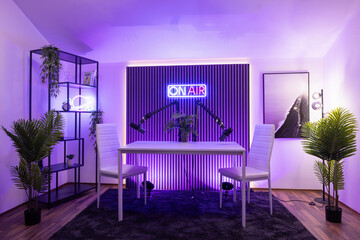 Modern podcast recording studio with professional lighting