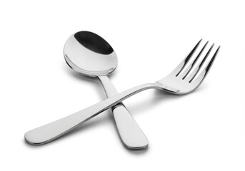 A shiny metal spoon and fork are crossed on a white surface, creating a simple and elegant composition