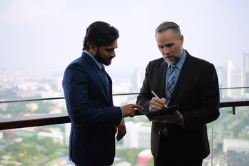 White collar workers are working at skyscraper.