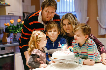 Adorable little toddler girl celebrating third birthday. Baby child, two kids boys brothers, mother...