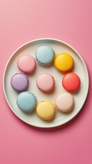 Obraz premium Pastel macarons arranged on white plate against bright pink background