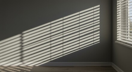 Obraz premium Sunlight Through Window Blinds Casting Shadows on Gray Wall