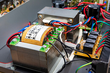 Electric power transformer in amplifier, inductor transformer coil with power cable, close-up
