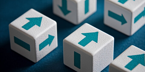 Close-up of white cubes with teal arrows, showing upward and downward directions, symbolizing choices, progress, or decision-making
