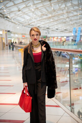 Fototapeta premium Woman in stylish outfit enjoys shopping at a modern retail mall