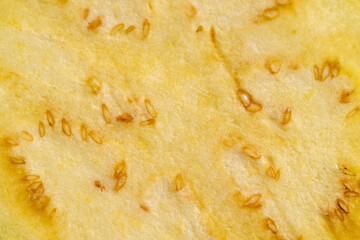 one eggplant sliced with seeds inside close up, ripe purple delicious eggplant sliced on the kitchen table, top view