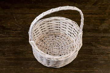 natural branches painted white from which a decorative basket is woven, the whole basket with a...