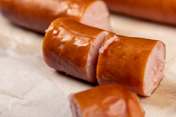thin pork sausage fried in oil, cut meat sausages on food paper