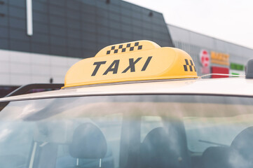 Close-up of the Taxi Lights sign. Background of a building on a city street.