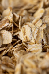 dry flakes made from oatmeal, a large amount of oat flakes for quick cooking of porridge without the need for cooking, side view