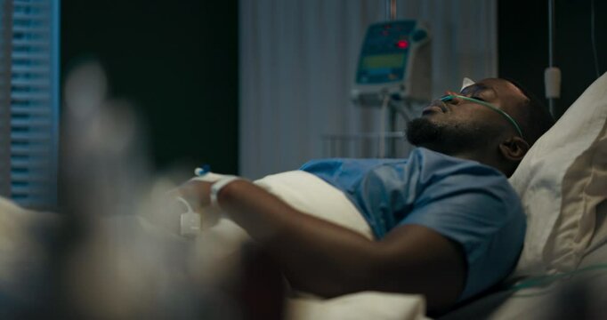 A patient is peacefully resting in a hospital bed recovers after an operation.