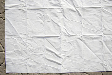 white crumpled and creased glued wrinkled paper poster texture background