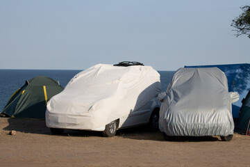 The cars are hidden in covers that protect them from solar overheating.