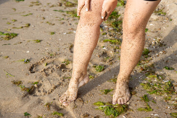 Woman walking on sandy beach cliff
