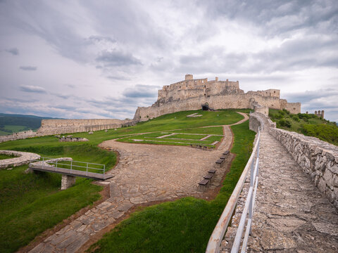 Stone walkway on the defensive walls of the lower part of Spi&scaron; Castle, Slovakia, with a view of the main upper castle structure.