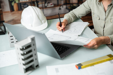 Architect working on a technichal blueprint project of an open space office