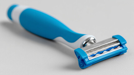 Detailed View of a Razor with a Folded Blade on a Light Gray Background