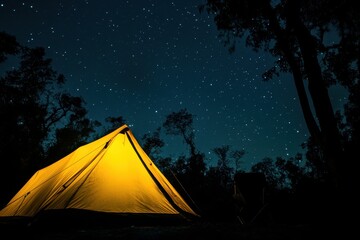 A bright yellow tent under a star-filled sky in a tranquil forest at night