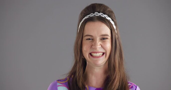 Wink, fashion and face of woman in studio for happiness, confident and vintage style. Mockup space, smile and portrait of person with emoji, gesture and flirt in retro clothes on gray background