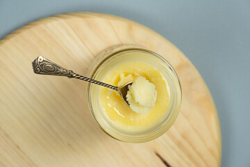 Ghee butter clarified butter jarred in a spoon top view.