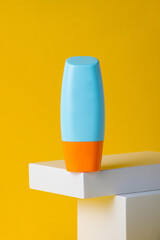 Blank tube with cosmetic product for moisturizing on yellow background