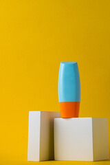 Blank tube with cosmetic product for moisturizing on yellow background